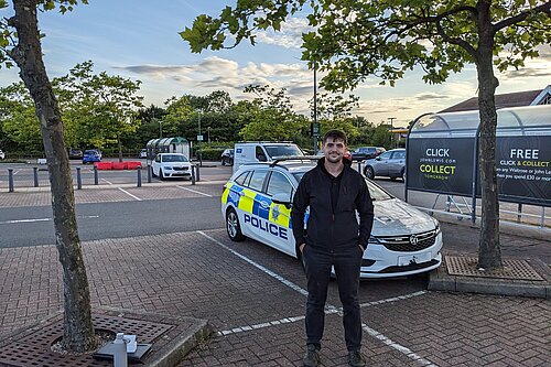 Aiden with police car