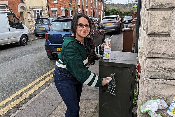 Natasha Chapman cleaning graffiti